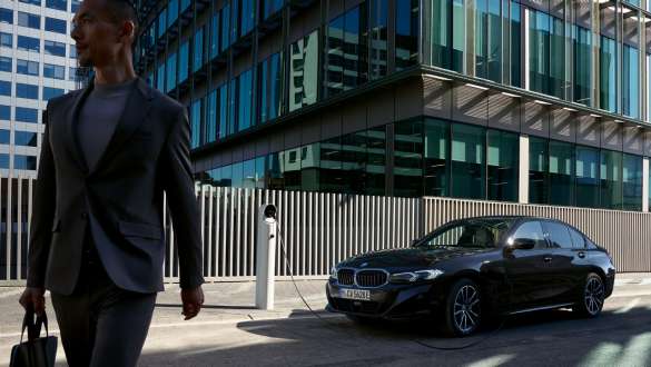 BMW 3 Series Saloon plug-in hybrid G20 three-quarter side view charging BMW 3 Series Saloon plug-in hybrid G20 three-quarter side view charging with model
