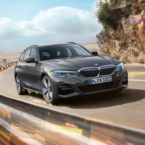 BMW 3er Touring, three-quarter front shot design BMW 3er Touring, three-quarter front shot driving on bridge in front of rural surroundings