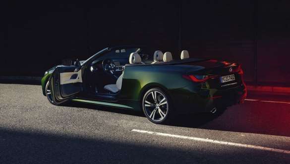Three-quarter side view BMW 4 Series Convertible G23 2020 BMW 4 Series Convertible G23 2020 San Remo Green metallic three-quarter side view drivers door open