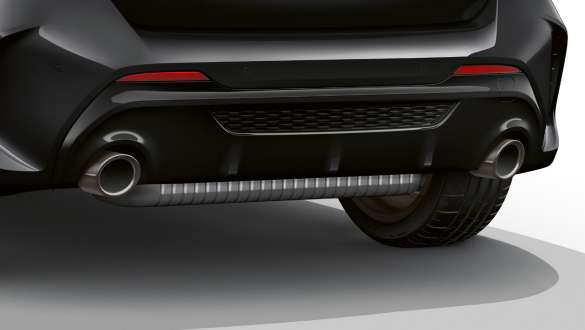 Tailpipes in Cerium Grey. BMW M135i xDrive in Black Sapphire metallic rear view with tailpipe trims left and right in Cerium Grey.