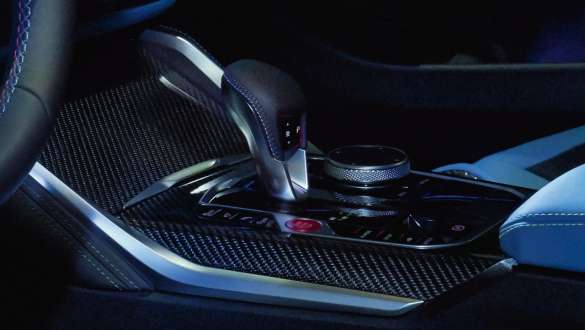 BMW M4 Competition Coupé G82 2020 M gear selector and gear shift paddles with carbon fibre trims interior close-up M gear selector and gear shift paddles with carbon fibre trims interior close-up BMW M4 Competition Coupé G82 2020