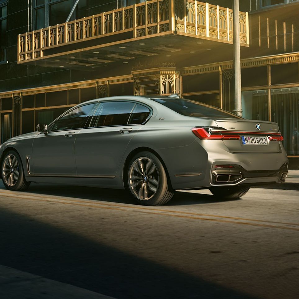 BMW M760Li xDrive Saloon with V12 engine BMW M760Li xDrive Saloon, lateral rear view in front of skyscrapers in urban setting