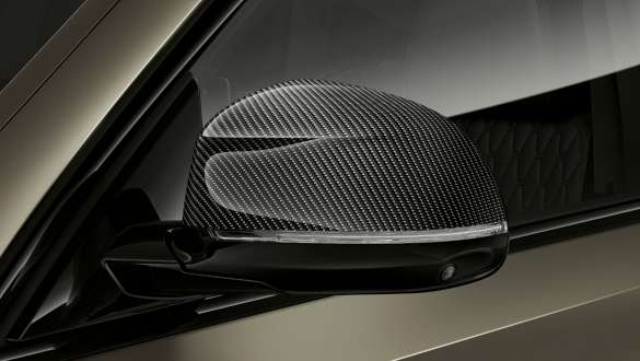 BMW X6 M50i M Carbon mirror caps. BMW X6 M50i M50d G06 SUV with close-up on M Carbon mirror caps.