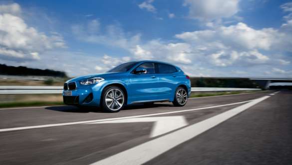 Plug-in hybrid BMW X2 xDrive25e F39 three-quarter side view driving Plug-in hybrid BMW X2 xDrive25e F39 three-quarter side view driving on the street