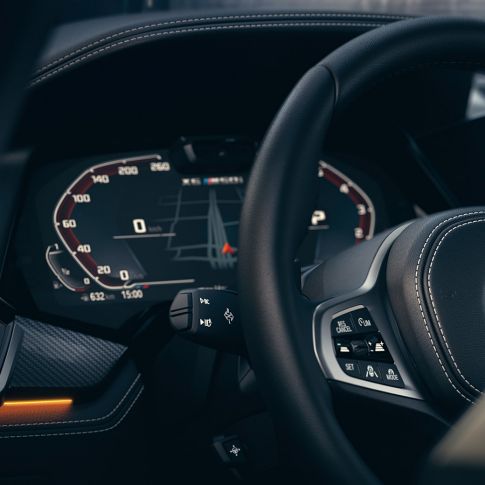 BMW assistance systems. Close-up of the BMW interior with focus on Instrument cluster .