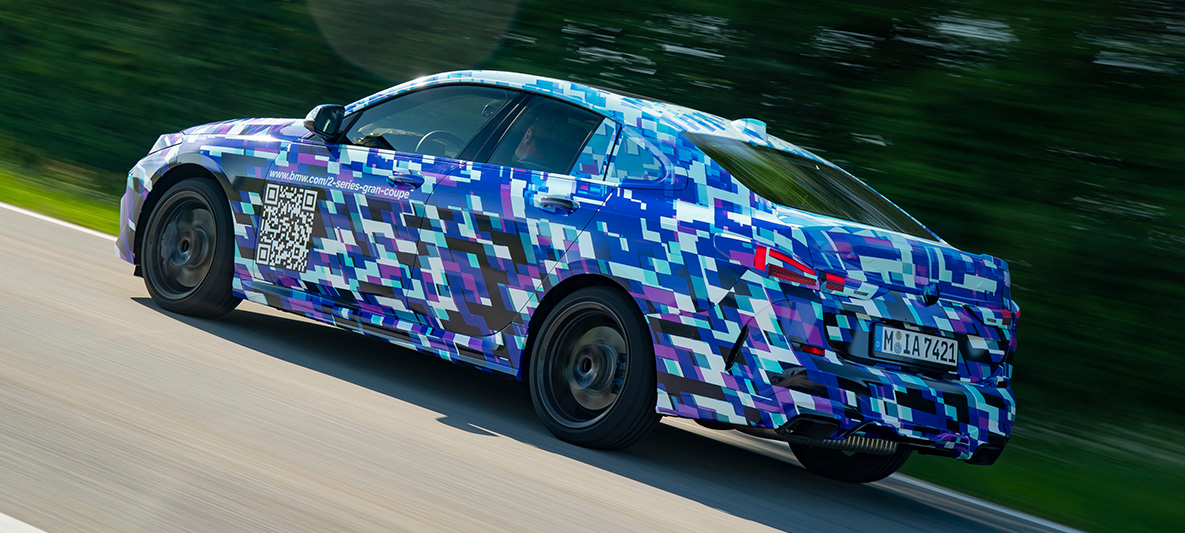 Driving dynamics BMW 2 Series Gran Coupé BMW M235i xDrive 2020 three-quarter side view disguised prototype car