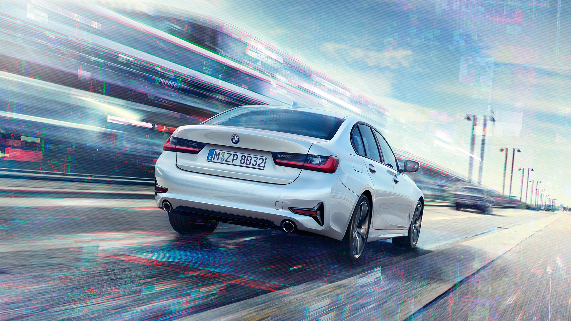 BMW 3 Series Saloon, 330e rear view. Three-quarter rear view of the driving BMW 3 Series Saloon 330e.
