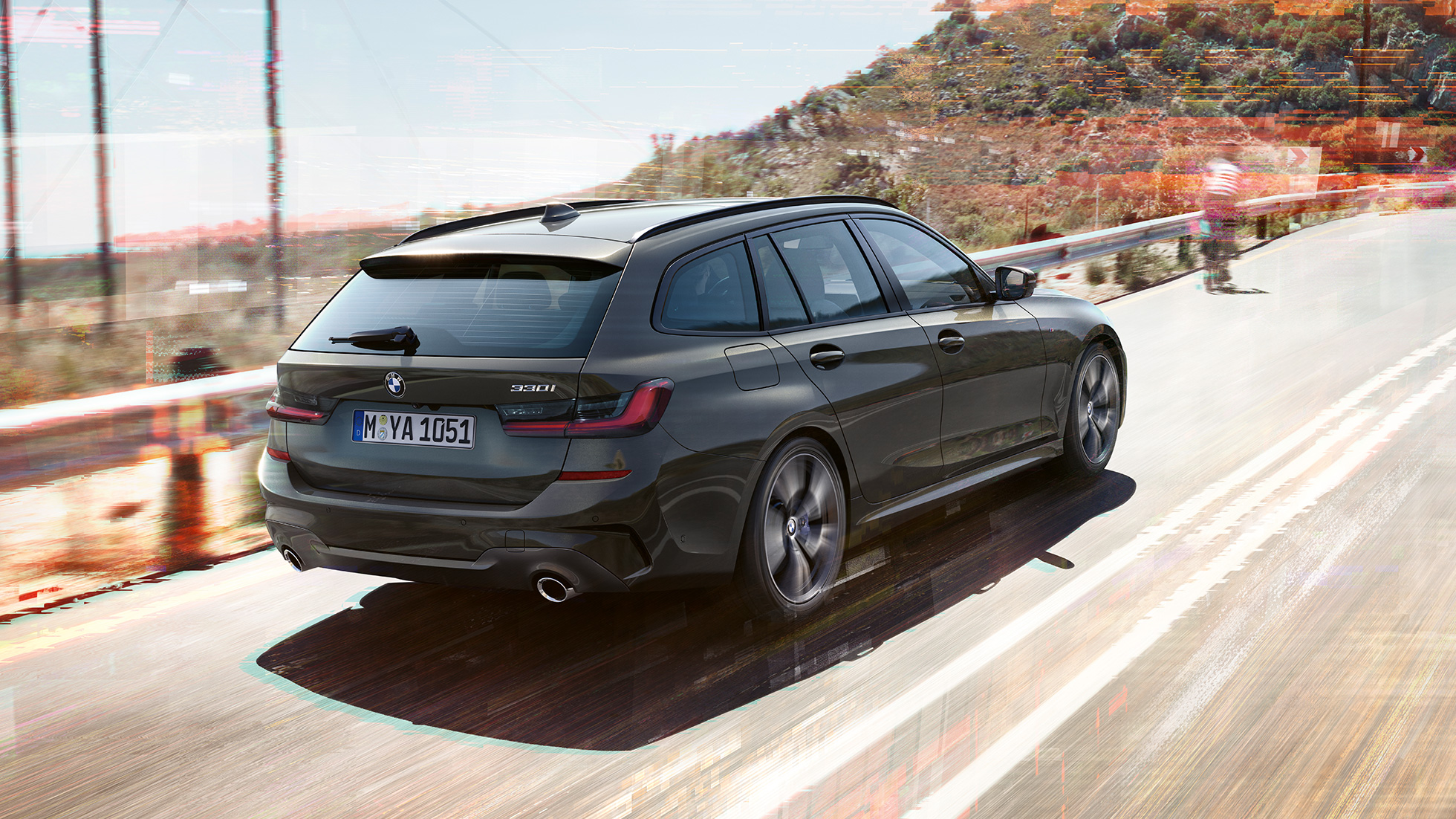 BMW 3er Touring, three-quarter rear shot BMW 3er Touring, three-quarter rear shot driving on bridge in front of rural surroundings