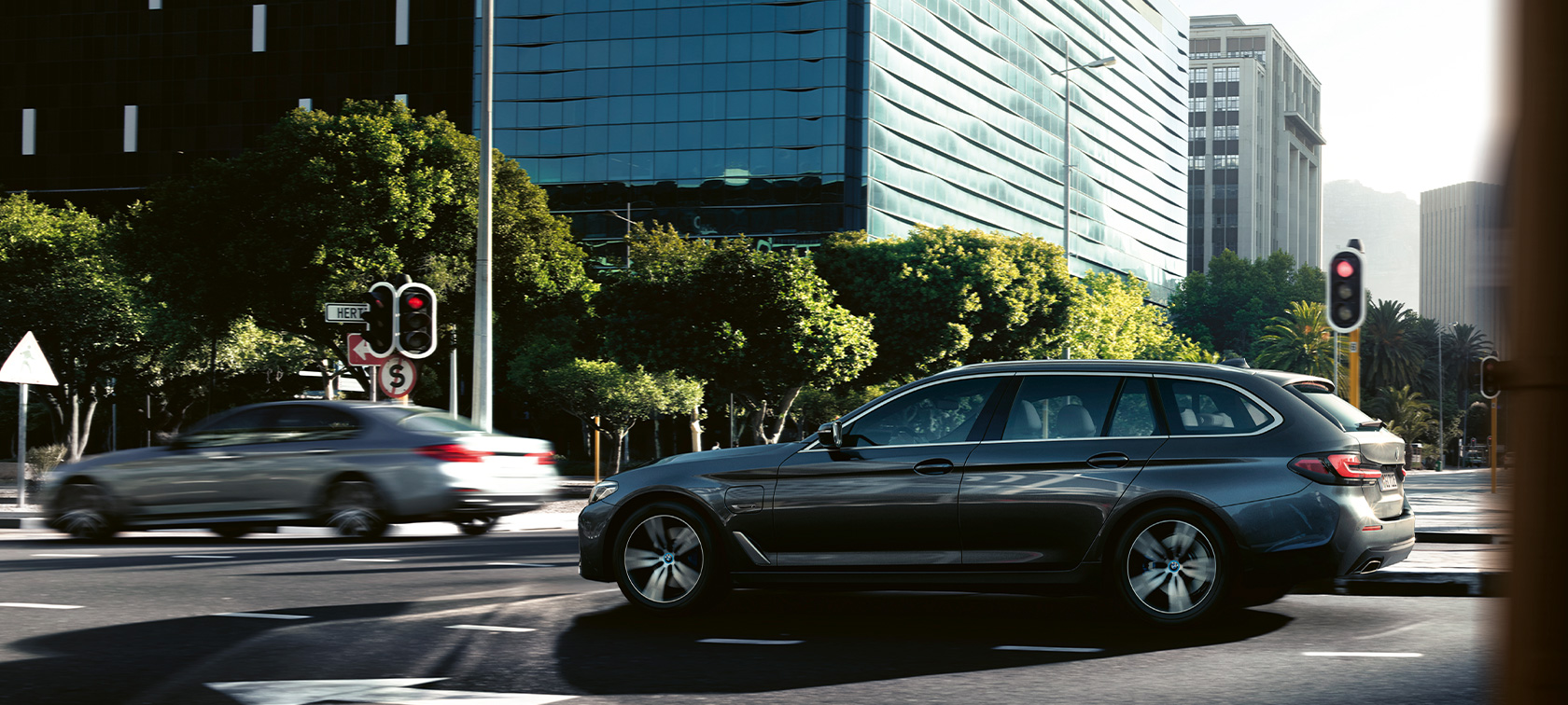 BMW 5 Series Touring G31 driving BMW 5 Series Touring G31 Facelift 2020 Sophisto Grey side view driving in city