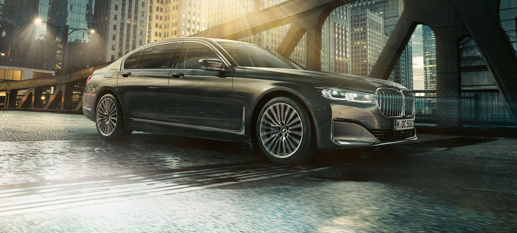 BMW 7 Series Saloon side view BMW 7 Series Saloon in side view with opened door in front of illuminated hotel