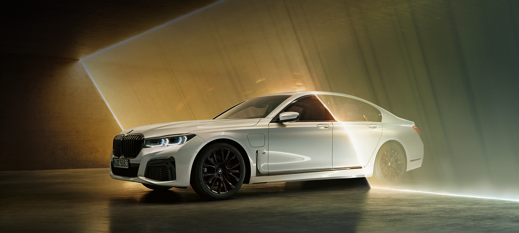 BMW 7 Series Saloon, white, three-quarter front view BMW 7 Series Saloon: white BMW in three-quarter front view surrounded by beam of light
