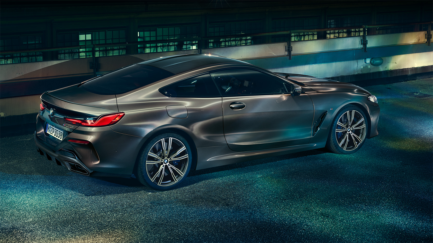 Still shot of the BMW 8 Series Coupé with BMW Individual equipment from the side in an urban setting at night Still shot of the BMW 8 Series Coupé with BMW Individual equipment from the side in an urban setting at night.