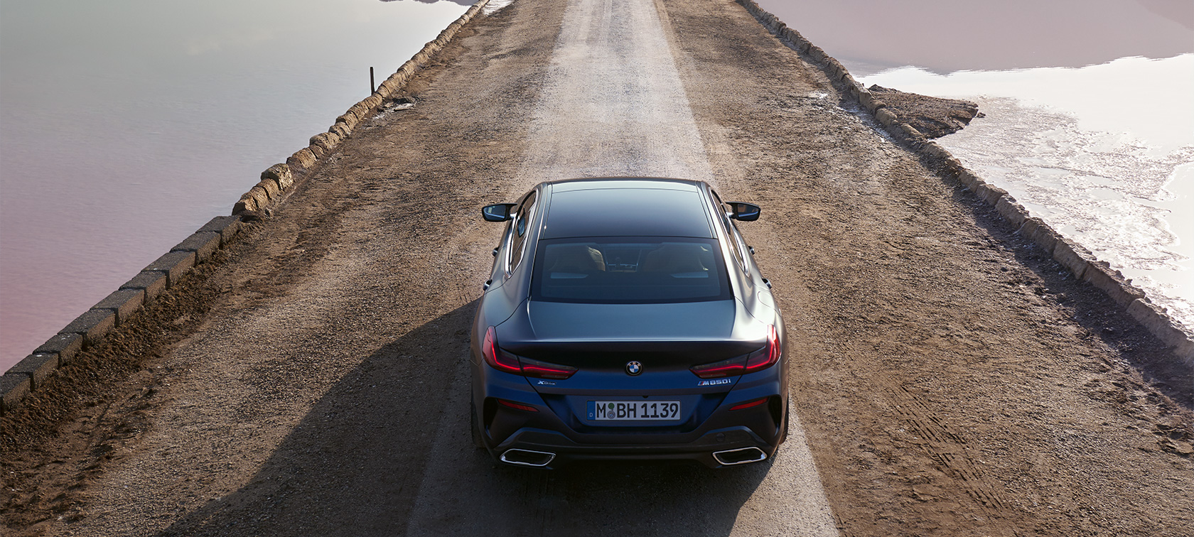 BMW 8 Series Gran Coupé G16 LCI Facelift 2022 BMW M850i xDrive BMW Individual Frozen Tanzanite Blue metallic three-quarter side view standing in front of a building BMW 8 Series Gran Coupé G16 LCI Facelift 2022 BMW M850i xDrive BMW Individual Frozen Tanzanite Blue metallic three-quarter side view standing in front of a building