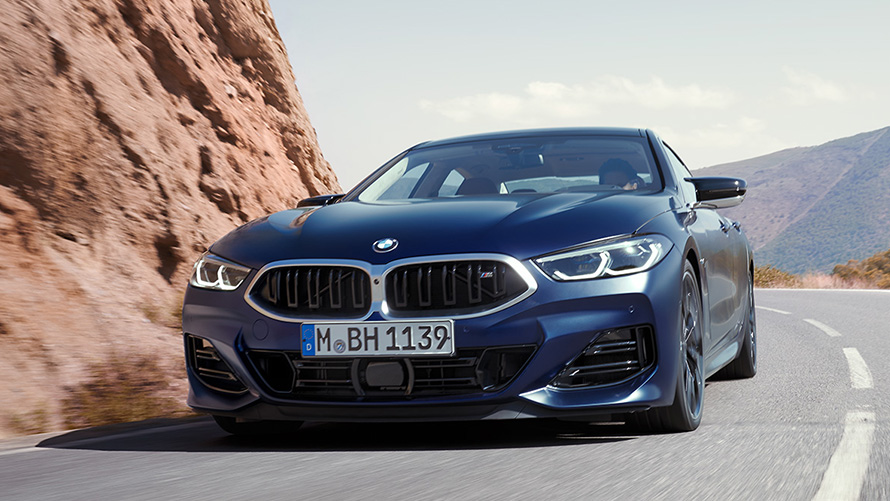 BMW 8 Series Gran Coupé (G16) three-quarter rear view driving BMW 8 Series Gran Coupé (G16) three-quarter rear view driving