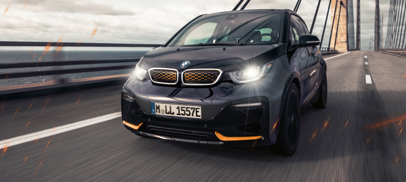 BMW i3 Unique Forever Edition I01 Storm Bay with Frozen E-Copper metallic accent three-quarter front view driving on highway
