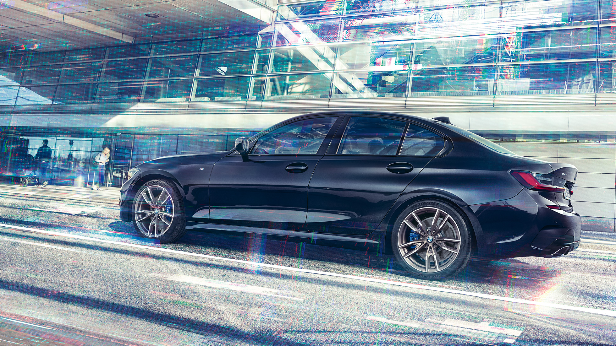 Side view BMW M340i xDrive Saloon BMW M340i xDrive Saloon G20 Sapphire Black metallic side view while driving