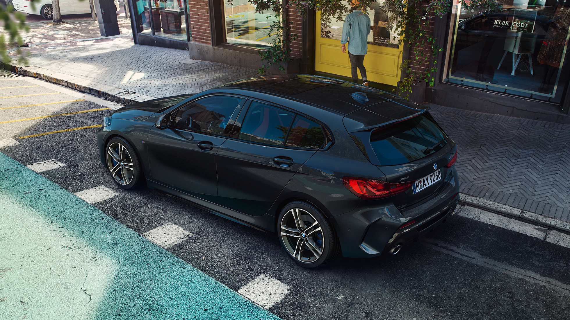 BMW M135i xDrive, parking. BMW M135i xDrive in Black Sapphire metallic parking, bird’s eye view of the side.