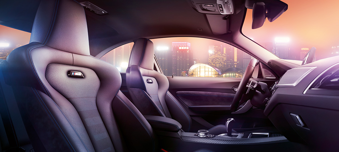 BMW M2 Competition Sport seats Cockpit and M Sport seats of the BMW M2 Competition, nocturnal skyline in the background