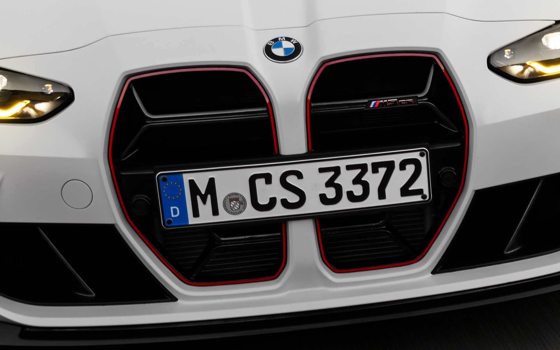 CS specific kidney grille in black with red special model signature BMW M3 CS G80 BMW M3 CS G80 CS specific kidney grille in black with red special model signature front view driving