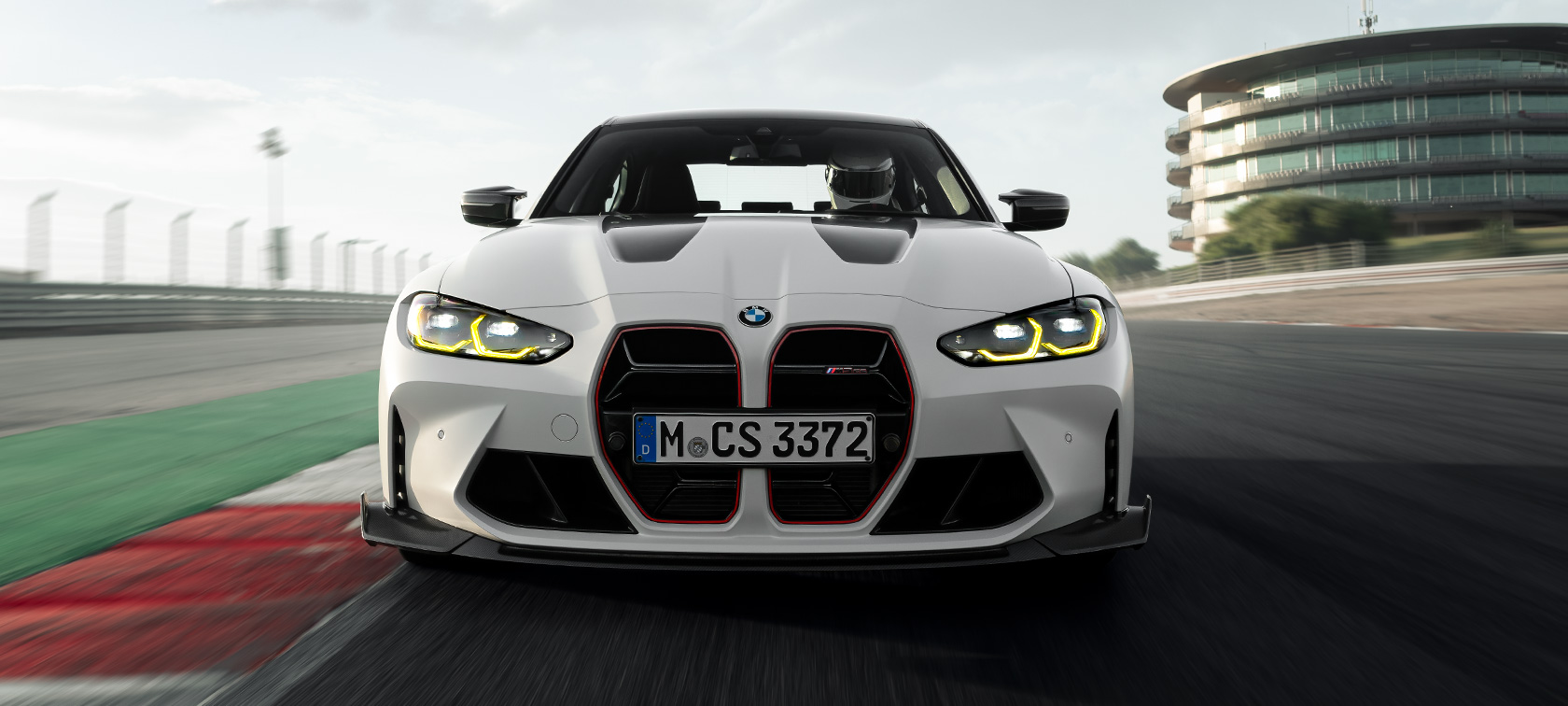 BMW M Performance Parts BMW M3 CS G80 BMW M3 CS G80 BMW M Performance Parts three-quarter front view driving on racetrack