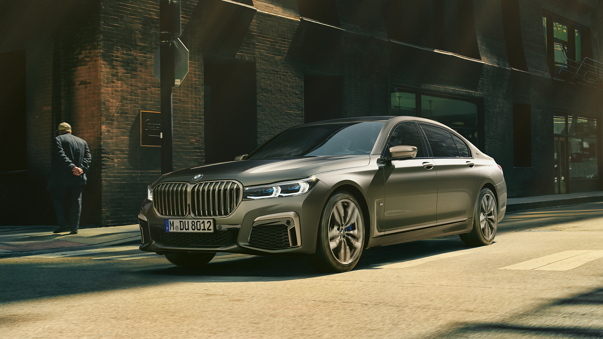 BMW M760Li xDrive Saloon in urban setting BMW M760Li xDrive Saloon, lateral front view driving on street in urban setting