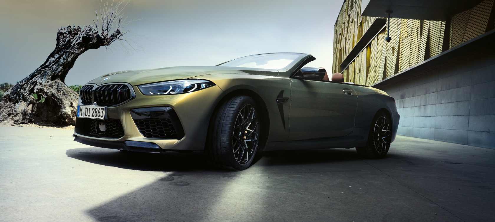 Three-quarter front view BMW M8 Competition Convertible F91 LCI 2022 BMW M8 Competition Convertible F91 LCI Facelift 2022 BMW Individual Brass metallic three-quarter front view low angle shot