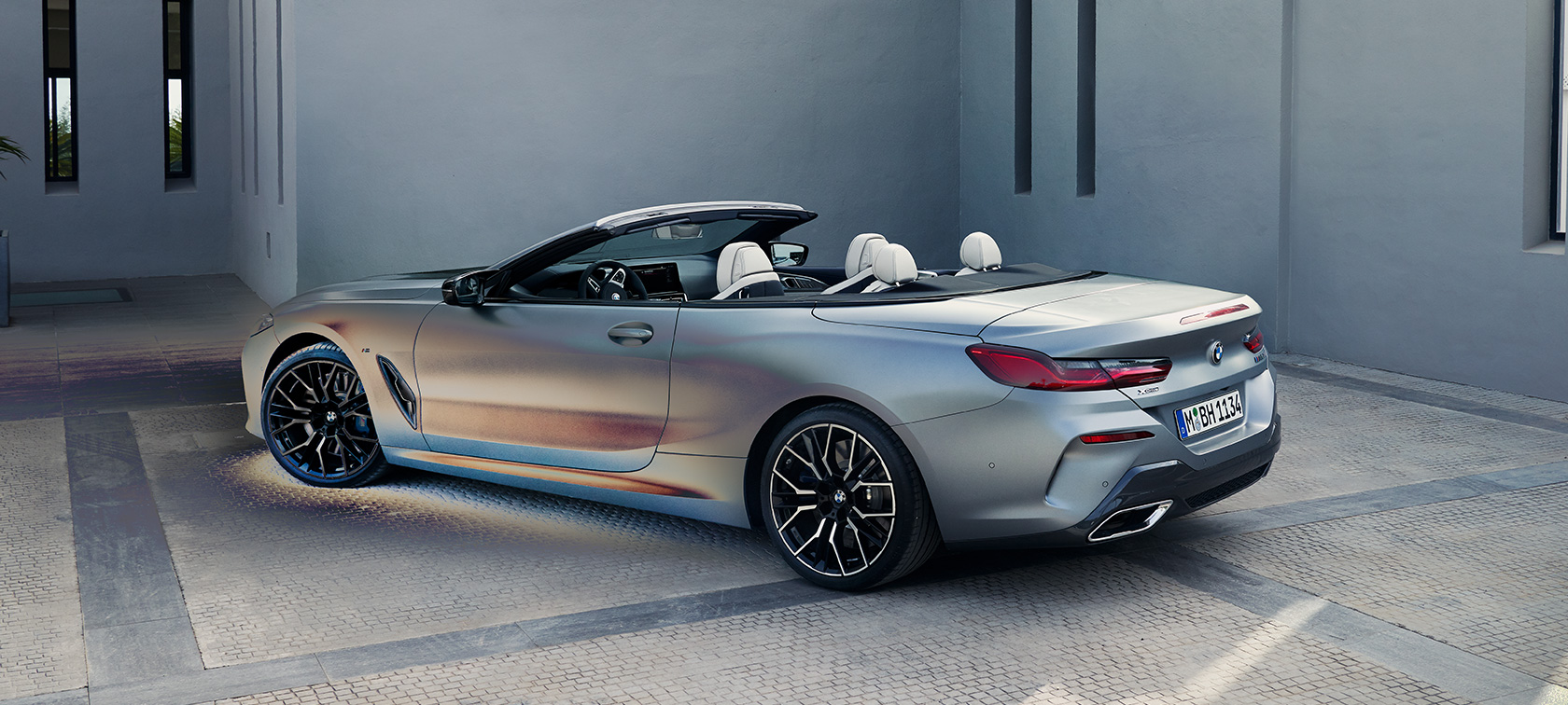 Three-quarter rear view BMW M850i xDrive Convertible G14 LCI Facelift 2022 BMW M850i xDrive Convertible G14 LCI Facelift 2022 BMW Individual Frozen Pure Grey metallic three-quarter rear view standing