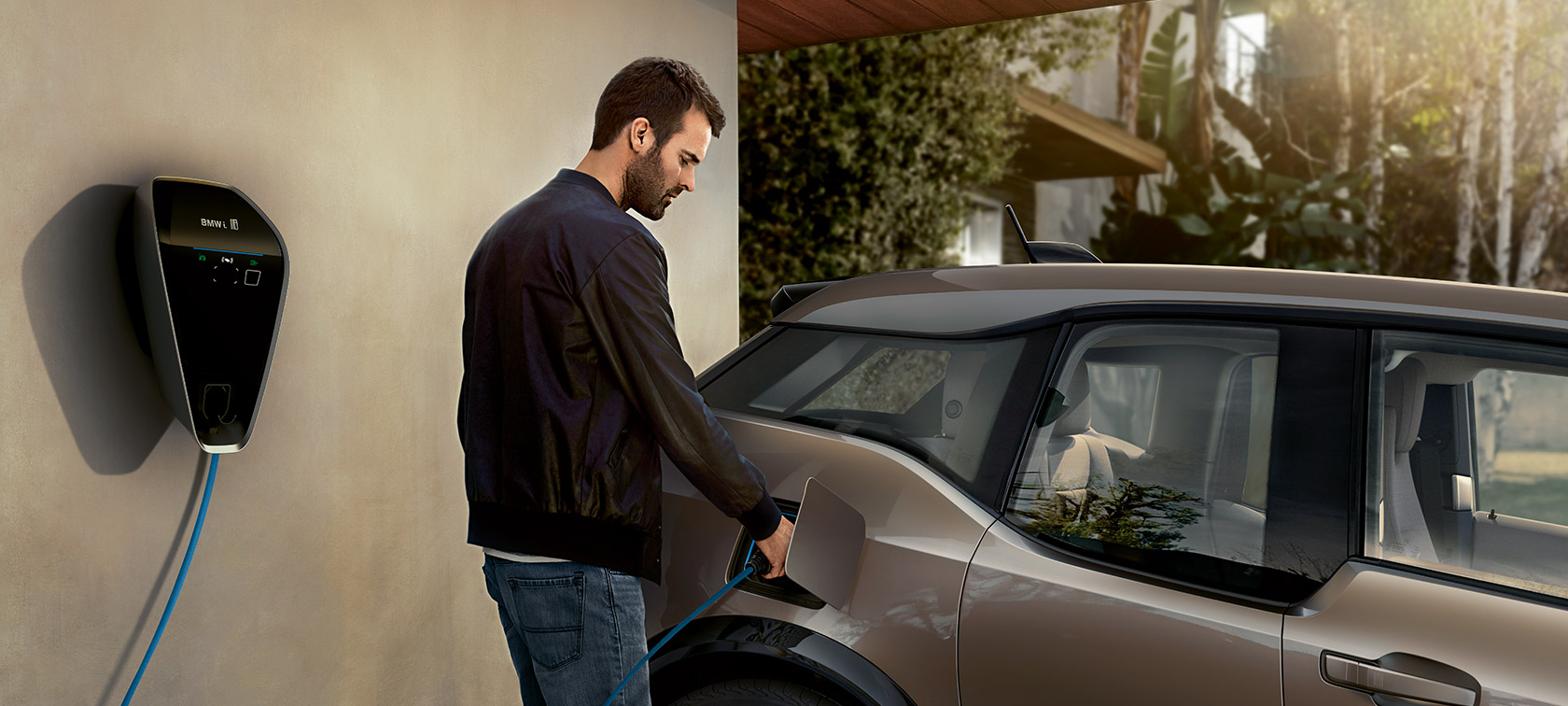 Man charges BMW i3. Man charges BMW i3 on the BMW i Wallbox.
