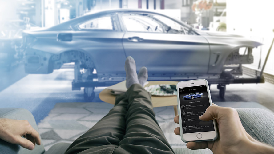 My Car Is Born Man sitting on sofa and using My Car Is Born on smartphone