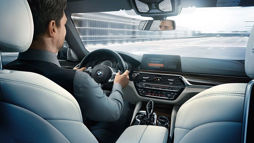 Man driving BMW with Intelligent Driving. Man driving BMW with Intelligent Driving.