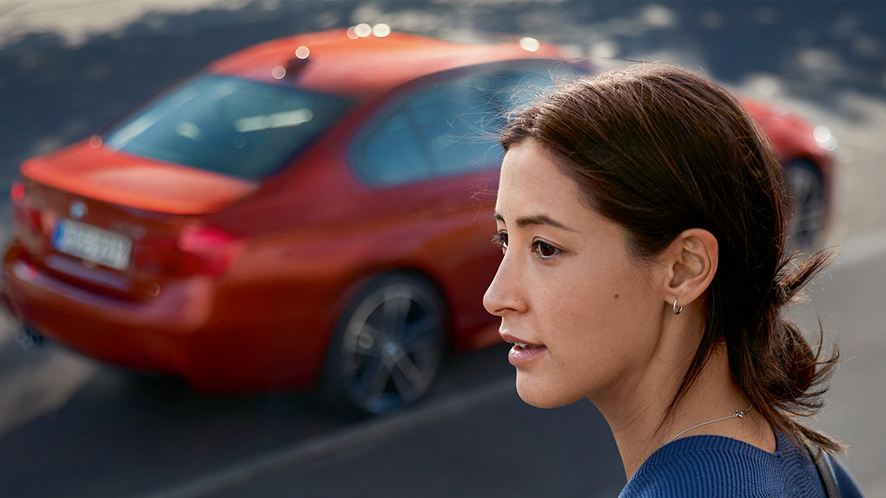 BMW Roadside Assistance. BMW Women at roadside with BMW Car.