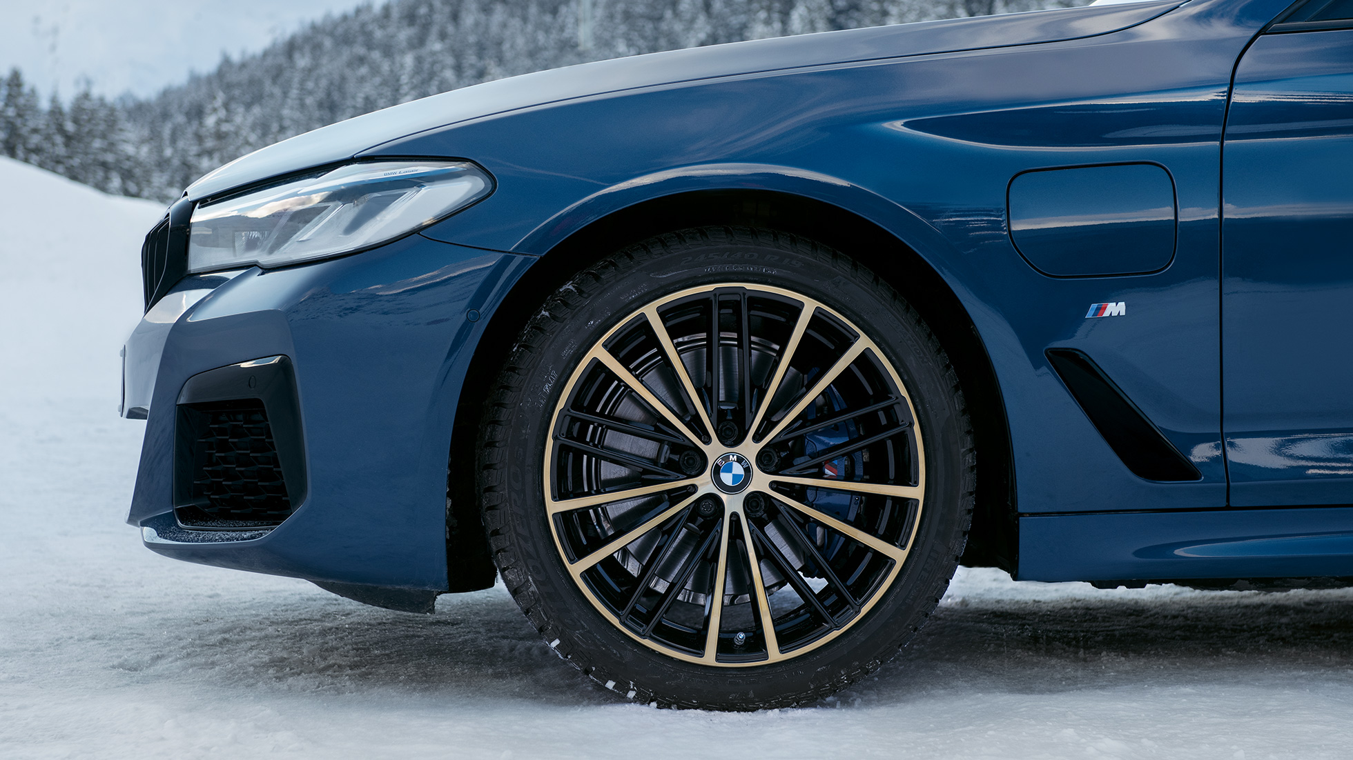 Front side view of an BMW M series with the cold wheatear wheel on snow