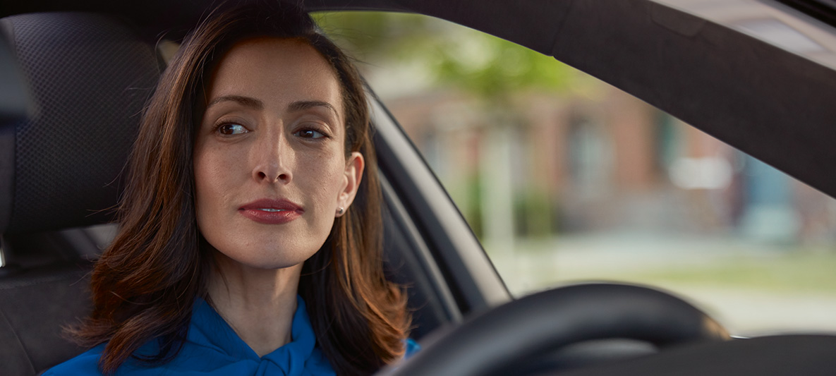 Woman looking to the side while driving.